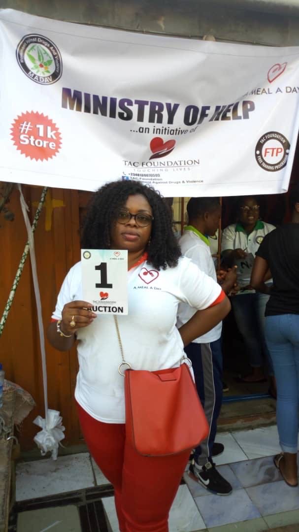 A volunteer at a Ministry of Help auction
