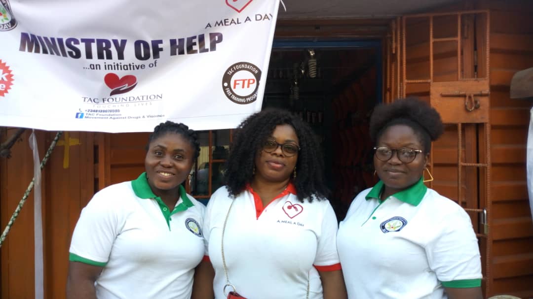 Three Ministry of Help volunteers under the initiative banner